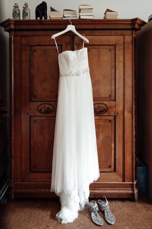 a wedding dress hanged on a closetの写真素材