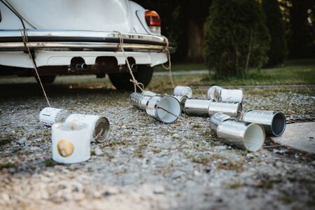 cans behind a wedding carの写真素材