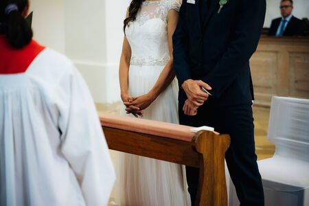 a bride and a groom standing on an isleの写真素材