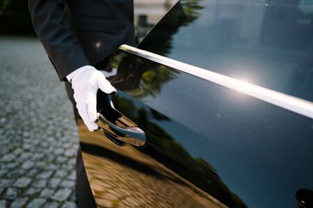 a driver opening the car doorの写真素材