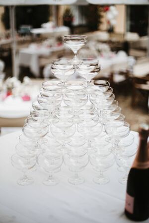 champagne glasses pyramid on a tableの写真素材
