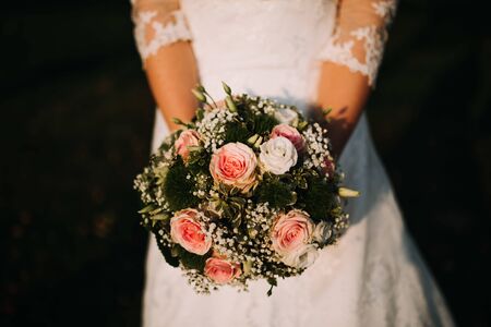 a bride holding a flower bouquetの写真素材