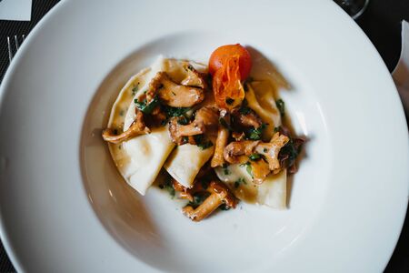Stewed mushrooms in sauce on a plateの写真素材