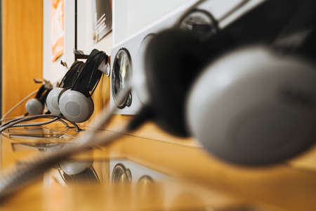 vintage headphones on a rustic or bare wooden table wallの写真素材