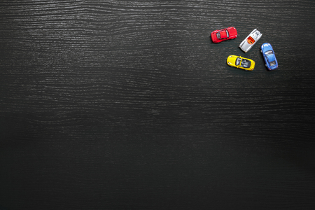 Black background with colorful toy carsの写真素材