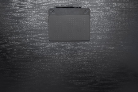 Black office desk business background with digital pen and tabletの写真素材