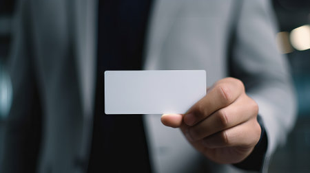 Businessman showing a blank business card with copy space, close upの素材