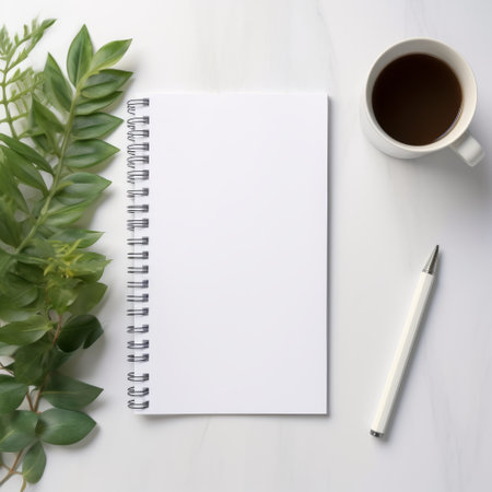 White office desk table with blank notebook, coffee cup and plant. Top view with copy space, flat lay.の素材