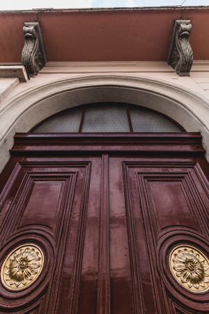 Vintage wooden door with golden knobsの写真素材