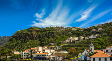 Clear blue sky over the beautiful coastal city of Tabua, on the tropical island of Madeira, Portugal.の写真素材