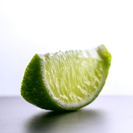 Close-up of lime slice. Isolated photo of a lime slice on a white background.の写真素材