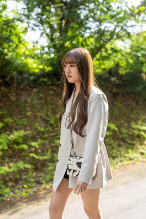 Portrait of asian woman in white coat and black shorts.の写真素材