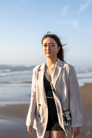 Asian woman walking on the beach in the morning, Lifestyle concept.の写真素材