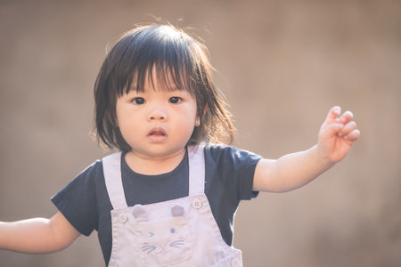 A one-year-old Chinese Malaysian girl playing on the children's playground equipment at KLCC Park in Kuala Lumpur City Centre, Malaysia.の写真素材