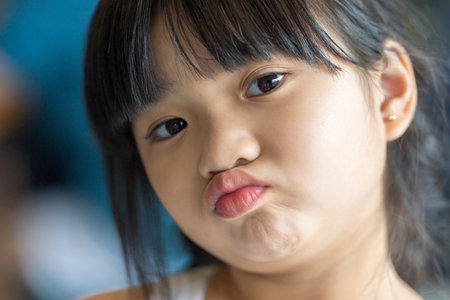 A six-year-old Malaysian girl enjoying an early summer afternoon at a stylish cafe in Selangor,...