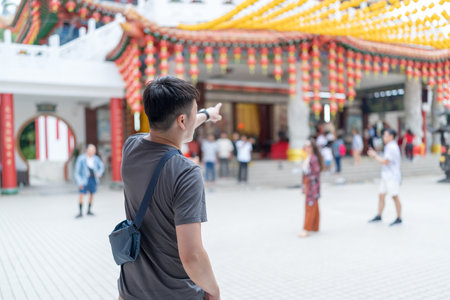 Chinese Malaysian couple in their 30s spending time at famous Chinese temple popular with tourists in Kuala Lumpur, Malaysia.の写真素材