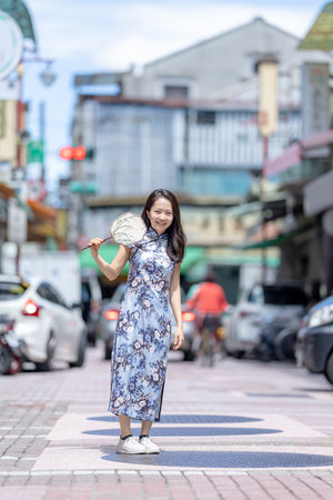 Woman in traditional Chinese clothing standing on Dihua Street Taipeiの写真素材