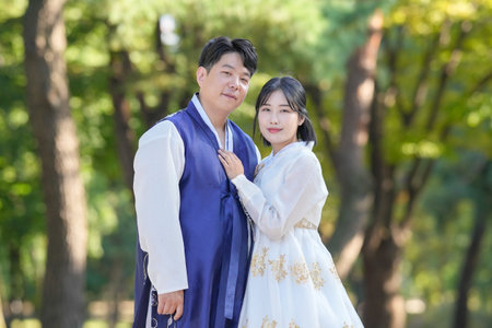 A Korean couple, a man in his 30s and a woman in her 20s, are spending time together in a historic park in Seoul, South Korea.の写真素材
