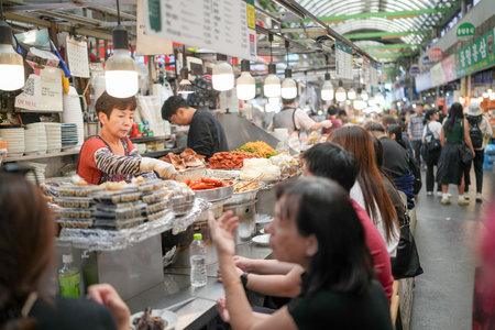October 11, 2024. Food scene at market with many traditional food stalls in Changgyeonggung-ro, Jongno District, Seoul, South Korea.のeditorial素材