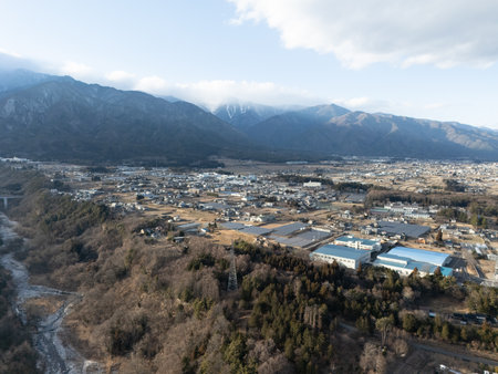 Aerial photograph of the countryside, including rice and private houses, in Komagane City, Nagano Prefecture, Japan in winter.の写真素材