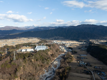 Aerial photograph of the countryside, including rice and private houses, in winter.の写真素材