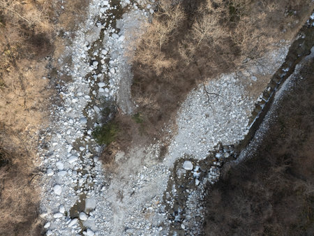 Aerial photograph of the countryside, including rice and private houses, including snow-covered Mt. Senjogatake and Mt. Kiso-Komagatake in Komagane City, Nagano Prefecture, Japan in winter.の写真素材