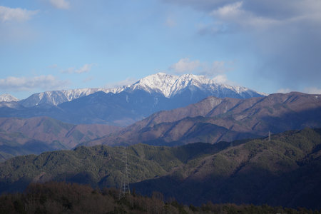 Snow-covered mountains in Komagane City, Nagano Prefecture, Japan in winter.の写真素材