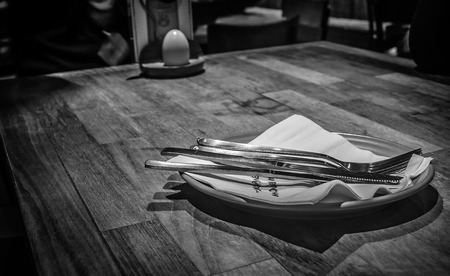 Fork and knife on a table - Monochromaticの写真素材