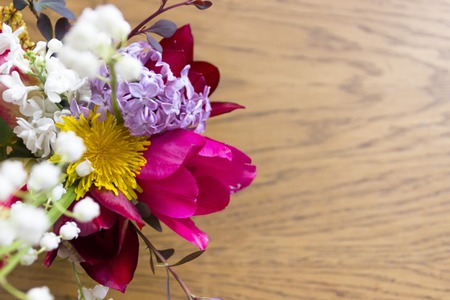 beautiful bouquet of flowers in vase on the wood table top viewの写真素材
