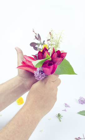 beautiful bouquet of flowers in a man's hand on white backgroundの写真素材