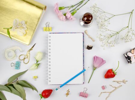 Flowers composition. Gifts and rose flowers on white wooden table. Women Day. Flat lay, top view,...