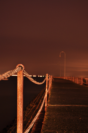 landing stage at night with metal polesの写真素材