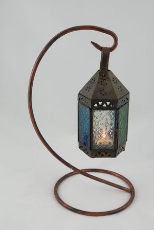 Moroccan Lamp with lit candle inside projecting shades and reflectionsの写真素材