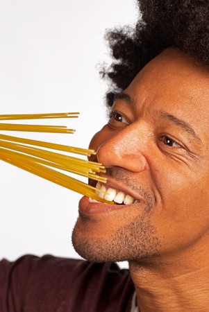 Biting into a bunch of spaghettis, concept for al dente cookingの写真素材