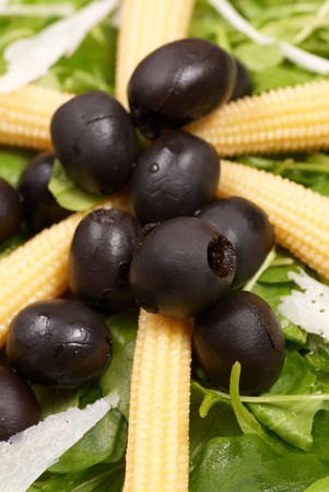Baby corn salad with rocket and black olivesの写真素材