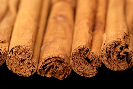 Cinnamon sticks taken with shallow DOF isolated on blackの写真素材
