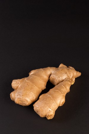 Raw ginger root taken on black backgroundの写真素材
