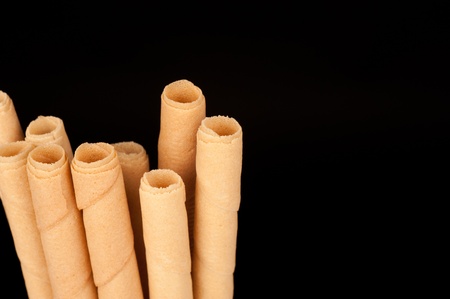 Detail take of rolled wafers isolated on blackの写真素材