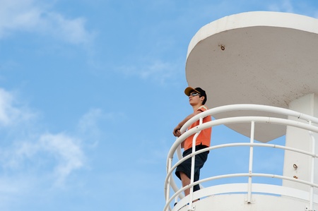 Lifeguard on duty on top of a watch-towerの写真素材