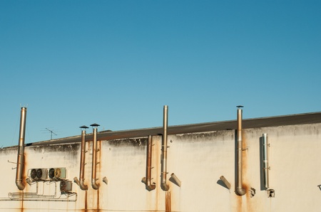 Industrial backyard, ugly run down exhaust pipes