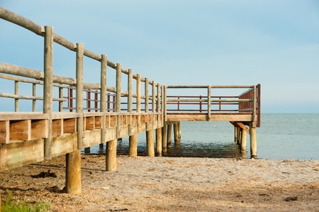 Wooden footbrige on an idyllic calm beachの写真素材
