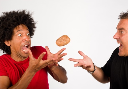 Passing on the hot potato, a conceptの写真素材