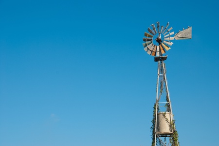 Traditional windmill pump extracting water from a wellの写真素材