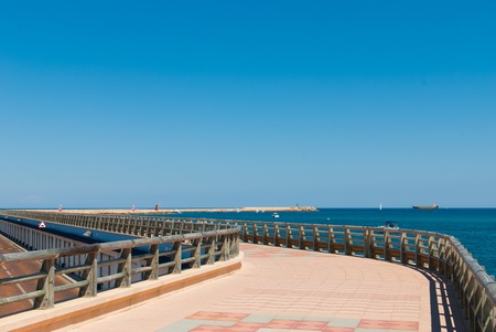 Scenic beach promenade on a breakwater moleの写真素材