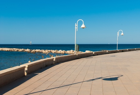 Idyllic Mediterranean beach promenade on a sunny afternoonの写真素材