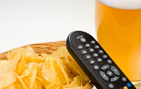 A snack, a pint and some television after workの写真素材