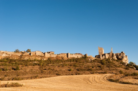The fortified town of Calatanazor, amidst harvested autumn fieldsの写真素材