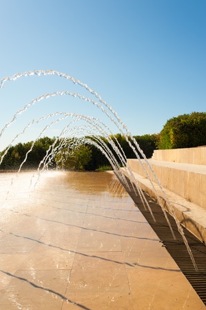 Simple arched fountain in a beautiful park settingの写真素材
