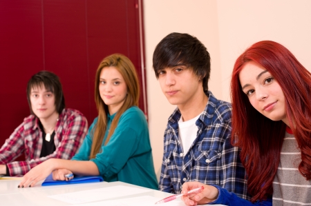 Teenage students in classroom looking at cameraの写真素材