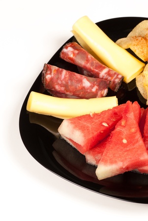 Freshly diced watermelon served with cold meat and cheese, a fruity starterの写真素材